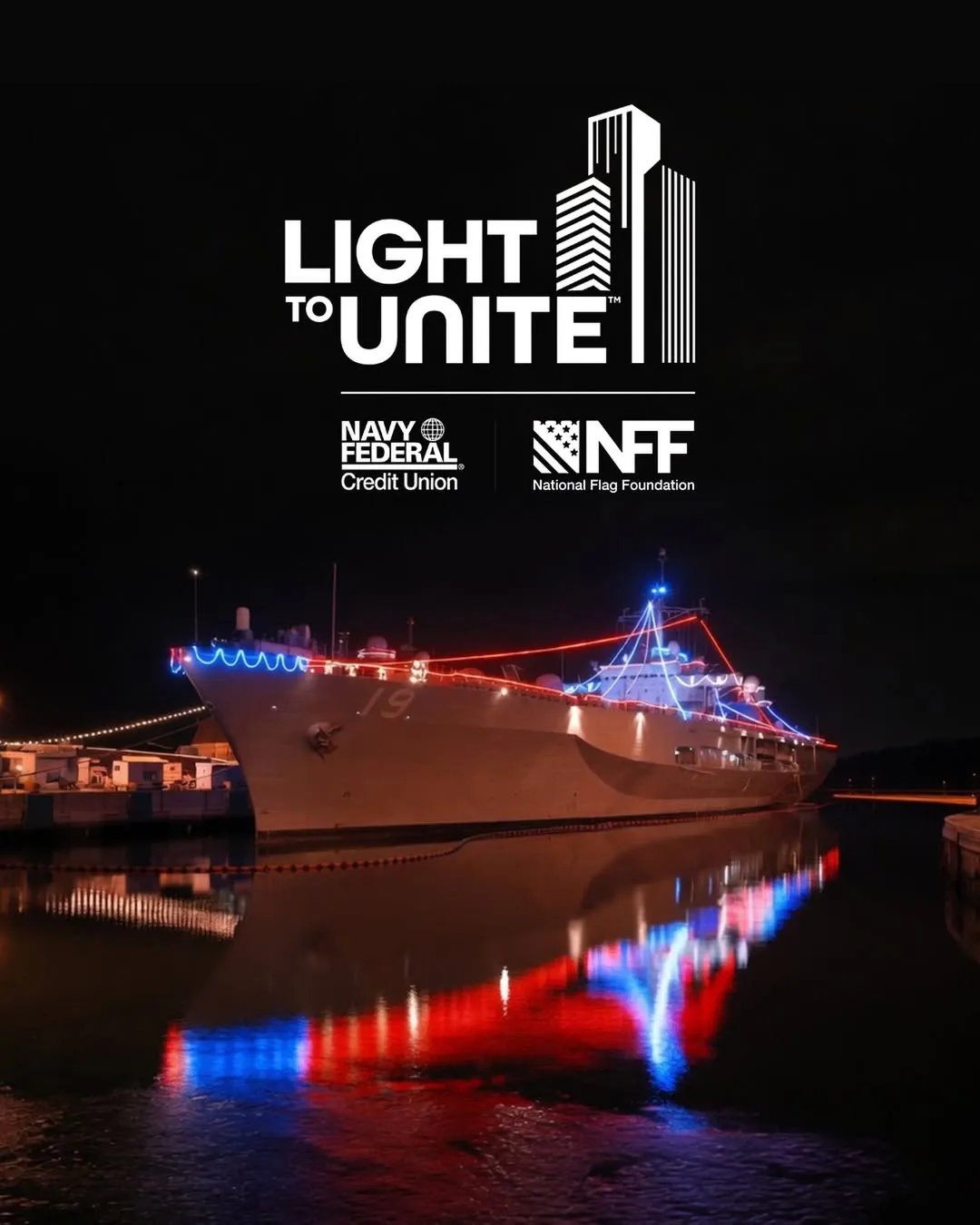 Light to Unite: a U.S. Navy ship lit in red, white, and blue at night